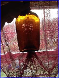 Amber T. J. Carty Port Jervis New York Embossed Slug Plate Strap Flask