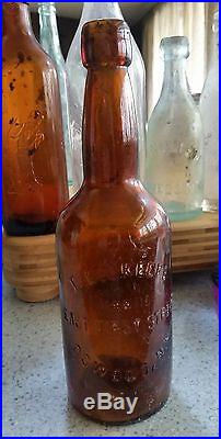 Antique O'Keefe stoneware jug & embossed glass bottle Oswego New York whiskey
