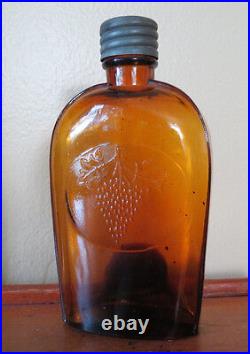 FLASK WITH EMBOSSED GRAPES in AMBER HENRY M GOBLE NEW YORK RARE BOTTLE